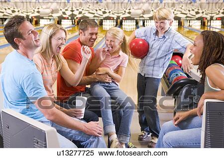 Family in bowling alley with two friends cheering and smiling View Large Photo Image Stock Photography - Family in bowling alley with two friends cheering and smiling. Fotosearch
