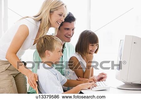Family in home office using computer smiling View Large Photo Image Stock Photograph - Family in home office using computer smiling. Fotosearch