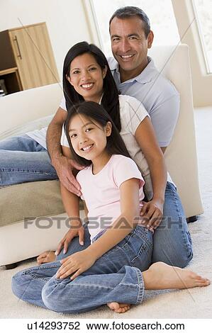 Family in living room smiling View Large Photo Image Stock Image - Family in living room smiling. Fotosearch