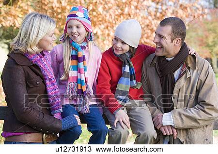 Family outdoors in park smiling (selective focus) View Large Photo Image Stock Image - Family outdoors in park smiling (selective focus). Fotosearch