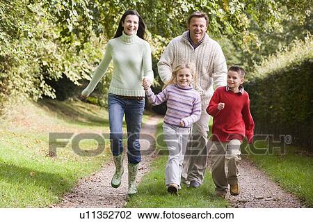 Family running on path outdoors smiling (selective focus) View Large Photo Image Stock Image - Family running on path outdoors smiling (selective focus). Fotosearch