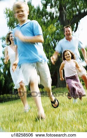 Family running outdoors smiling View Large Photo Image Stock Photograph - Family running outdoors smiling. Fotosearch