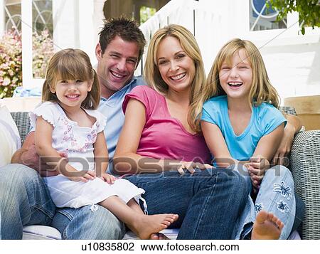 Family sitting on patio smiling View Large Photo Image Stock Image - Family sitting on patio smiling. Fotosearch