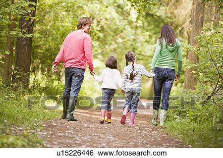 Family walking on path holding hands View Large Photo Image Stock Photograph - Family walking on path holding hands. Fotosearch
