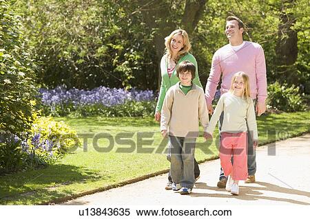 Family walking on path holding hands smiling View Large Photo Image Stock Photography - Family walking on path holding hands smiling. Fotosearch