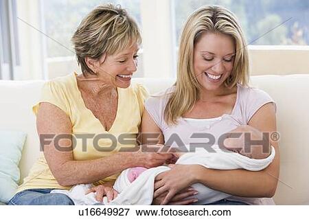 Grandmother and mother in living room with baby smiling View Large Photo Image Stock Photo - Grandmother and mother in living room with baby smiling. Fotosearch