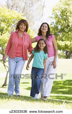Stock Photograph - Grandmother with adult daughter and grandchild in park. Fotosearch