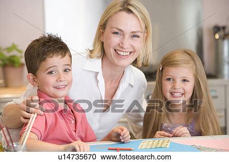 Woman and two young children in kitchen with art project smiling View Large Photo Image Stock Image - Woman and two young children in kitchen with art project smiling. Fotosearch