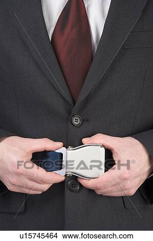 Picture - Businessman Fastening Safety Belt. Fotosearch