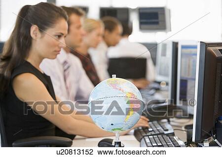 Five businesspeople in office space with desk globe in foreground View Large Photo Image Stock Image - Five businesspeople in office space with desk globe in foreground. Fotosearch