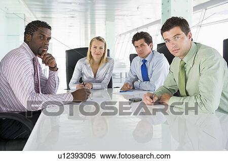Four businesspeople in a boardroom View Large Photo Image Stock Photography - Four businesspeople in a boardroom. Fotosearch