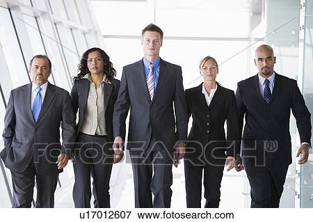Stock Photo - Group of co-workers walking in office space (high key). Fotosearch