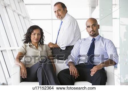 Three businesspeople sitting indoors (high key/selective focus) View Large Photo Image Picture - Three businesspeople sitting indoors (high key/selective focus). Fotosearch