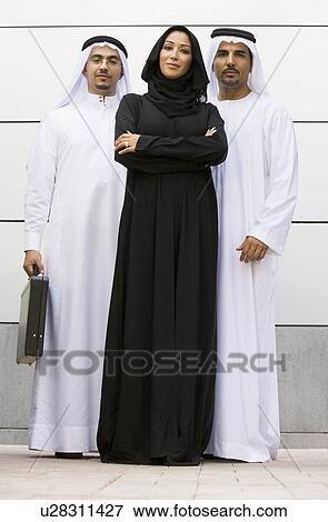 Three businesspeople standing outdoors smiling View Large Photo Image Stock Photo - Three businesspeople standing outdoors smiling. Fotosearch