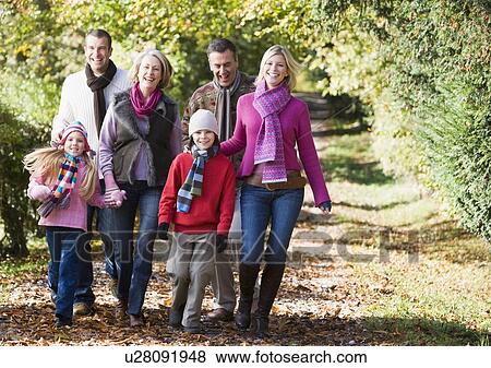 Family walking outdoors in park and smiling View Large Photo Image Stock Photo - Family walking outdoors in park and smiling. Fotosearch
