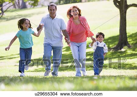 Picture - Grandparents running with grandchildren.. Fotosearch