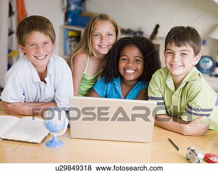 Group Of Young Children Doing Their Homework On A Laptop View Large Photo Image Stock Photo - Group Of Young Children Doing Their Homework On A Laptop. Fotosearch
