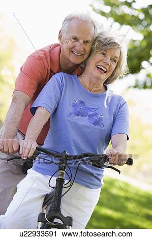 Senior couple on a bicycle View Large Photo Image Stock Image - Senior couple on a bicycle. Fotosearch
