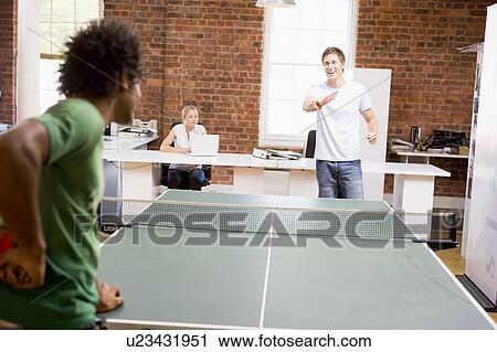 Two men in office space playing ping pong View Large Photo Image Stock Image - Two men in office space playing ping pong. Fotosearch
