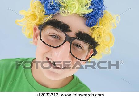 Young boy wearing clown wig and fake nose smiling View Large Photo Image Stock Image - Young boy wearing clown wig and fake nose smiling. Fotosearch