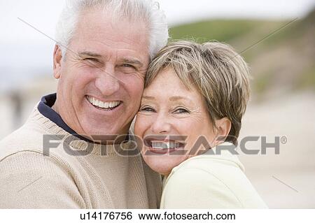 Couple at the beach smiling View Large Photo Image Stock Photograph - Couple at the beach smiling. Fotosearch