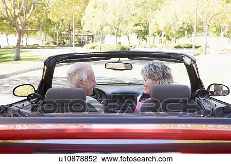Couple in convertible car smiling View Large Photo Image Stock Image - Couple in convertible car smiling. Fotosearch