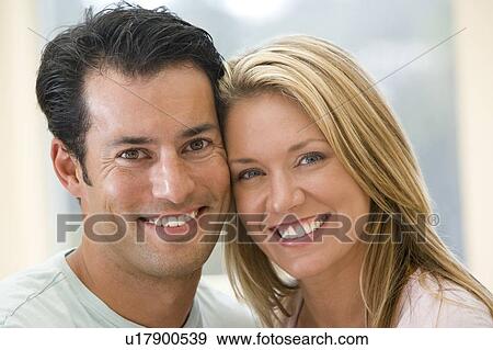 Stock Photo - Couple indoors smiling. Fotosearch