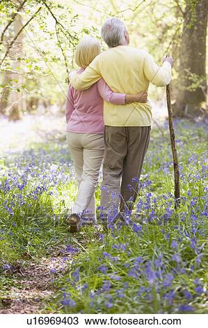 Couple walking outdoors with walking stick View Large Photo Image Stock Image - Couple walking outdoors with walking stick. Fotosearch