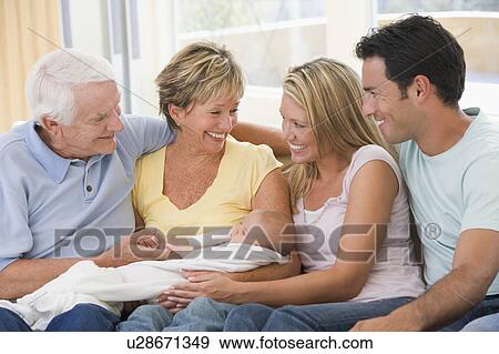 Stock Photo - Family in living room with baby smiling. Fotosearch