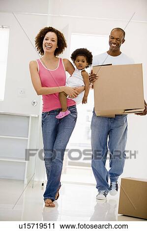 Family moving into new home smiling View Large Photo Image Stock Image - Family moving into new home smiling. Fotosearch