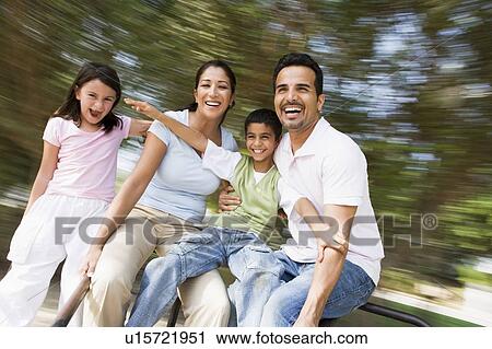 Family outdoors in playground spinning and smiling (blur) View Large Photo Image Stock Image - Family outdoors in playground spinning and smiling (blur). Fotosearch