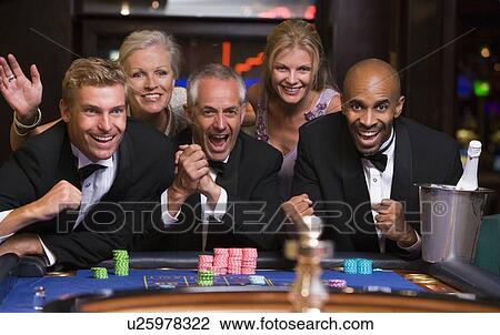 Five people in casino playing roulette smiling (selective focus) View Large Photo Image Stock Image - Five people in casino playing roulette smiling (selective focus). Fotosearch