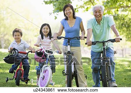Grandparents bike riding with grandchildren. View Large Photo Image Stock Image - Grandparents bike riding with grandchildren.. Fotosearch