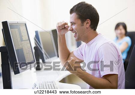 Man in computer room cheering and smiling View Large Photo Image Stock Image - Man in computer room cheering and smiling. Fotosearch