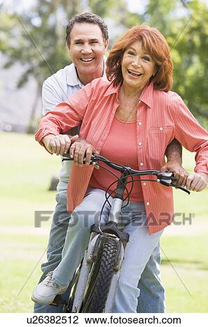 Stock Image - Mature couple bike riding.. Fotosearch