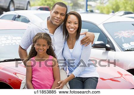 Mother and father with young daughter shopping for a new car View Large Photo Image Stock Photography - Mother and father with young daughter shopping for a new car. Fotosearch