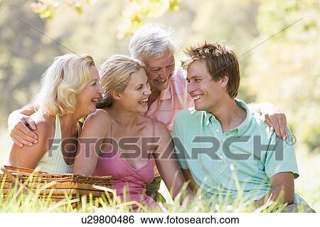 Stock Photograph - Parents with adult children on picnic. Fotosearch