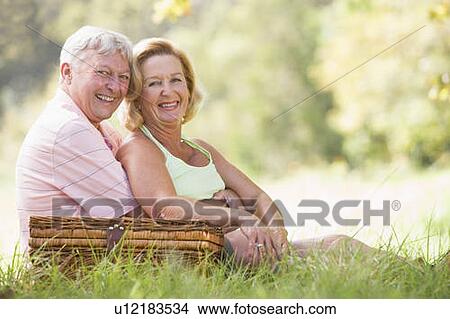 Picture - Couple at a picnic smiling. Fotosearch