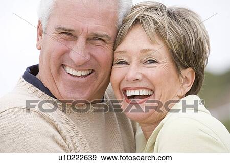 Couple at the beach smiling View Large Photo Image Stock Photo - Couple at the beach smiling. Fotosearch