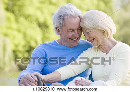 Couple outdoors laughing View Large Photo Image Stock Image - Couple outdoors laughing. Fotosearch