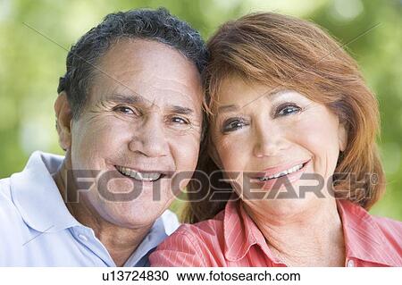 Stock Image - Couple outdoors smiling. Fotosearch