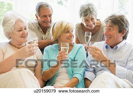 Five friends in living room drinking champagne and smiling View Large Photo Image Stock Photo - Five friends in living room drinking champagne and smiling. Fotosearch