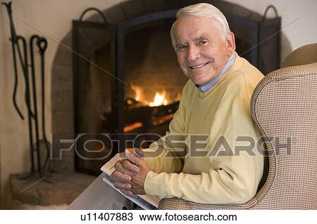 Man in living room with newspaper smiling View Large Photo Image Stock Image - Man in living room with newspaper smiling. Fotosearch