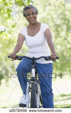 Senior woman on a bicycle View Large Photo Image Stock Photo - Senior woman on a bicycle. Fotosearch