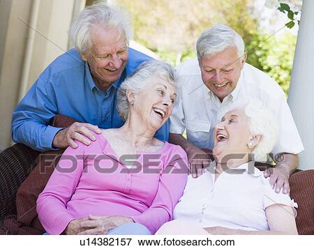 Stock Photo - Two senior women sitting outdoors on a chair. Fotosearch