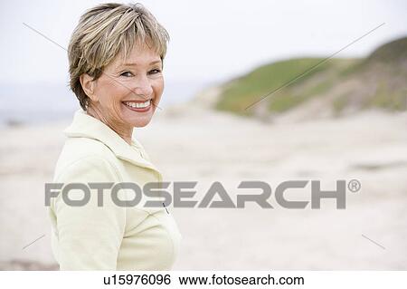 Woman at the beach smiling View Large Photo Image Stock Photograph - Woman at the beach smiling. Fotosearch
