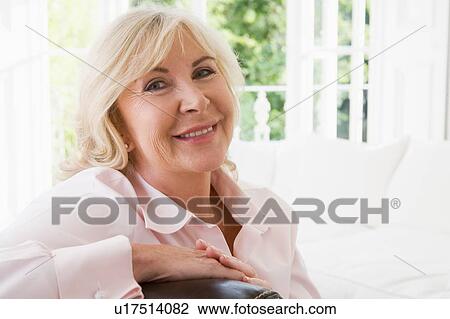Woman in living room smiling View Large Photo Image Stock Image - Woman in living room smiling. Fotosearch