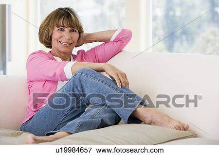 Woman in living room smiling View Large Photo Image Stock Photo - Woman in living room smiling. Fotosearch