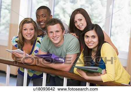Five students in corridor leaning on railing with notebooks View Large Photo Image Stock Image - Five students in corridor leaning on railing with notebooks. Fotosearch