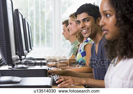 Four people sitting at computer terminals (selective focus/high key) View Large Photo Image Stock Image - Four people sitting at computer terminals (selective focus/high key). Fotosearch